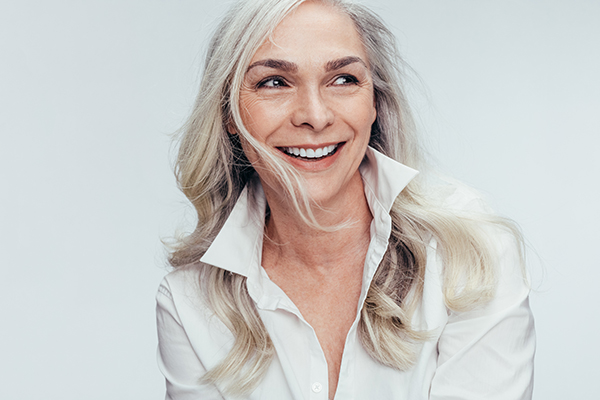 A woman with blonde hair smiling at the camera.